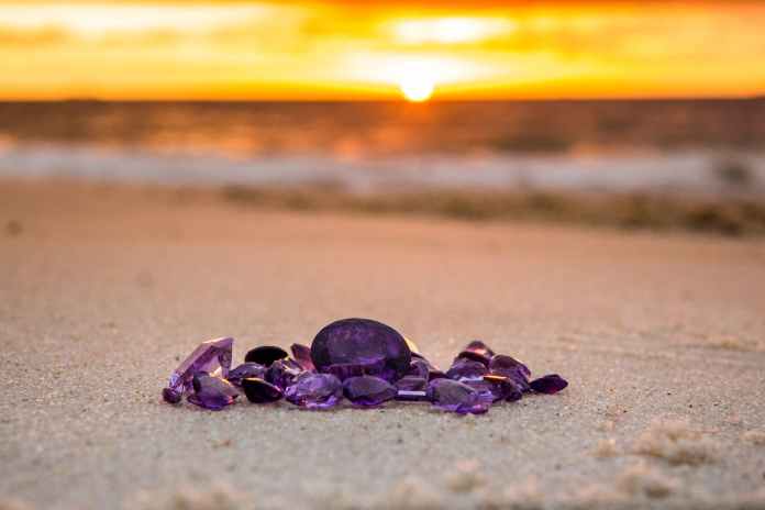 a close up shot of gems on sand