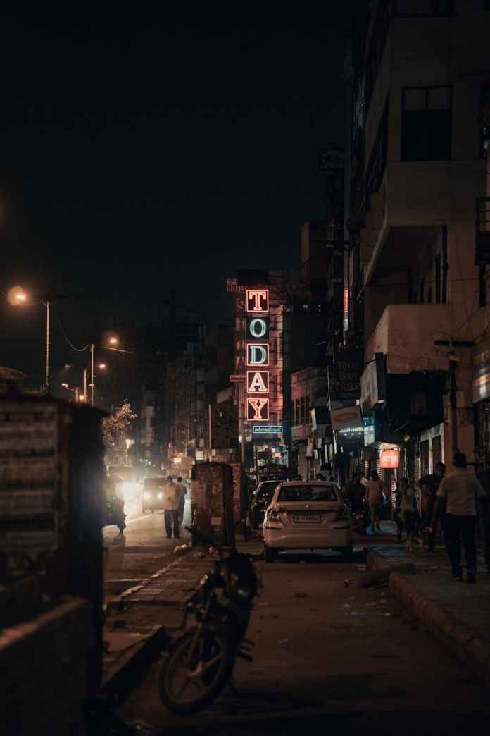 a white car parked near a today neon sign